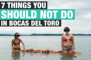 To women stack starfish onto a board in bocas del toro, Panama