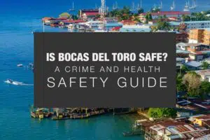 The cover image for the article titled, "Is Bocas del Toro Safe? A Crime and Health Safety Guide," By the Bocas del Toro Blog, with white font on a black background with the background of Bocas Town on Isla Colon from the air.