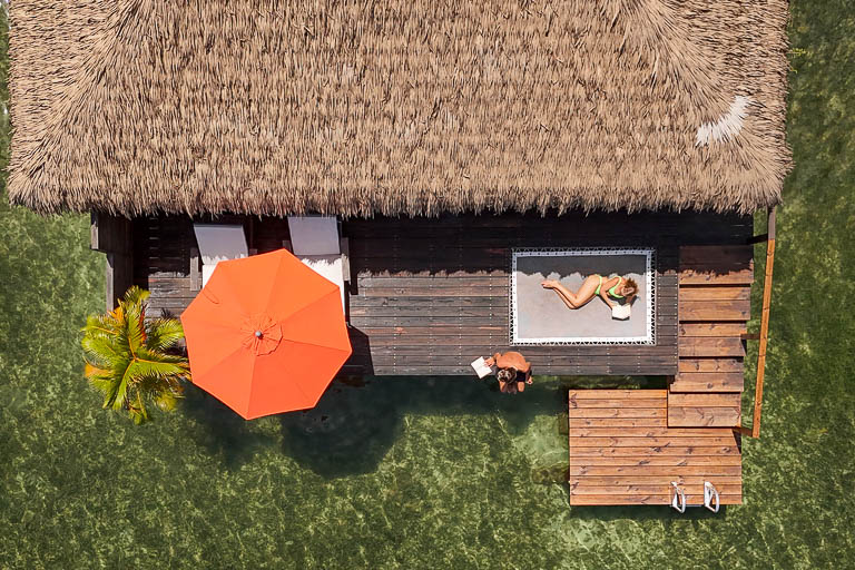 Is Bocas del Toro Worth Visiting? The drone from sol bungalows with influencers Britt and Mitch on the deck of the bungalow.