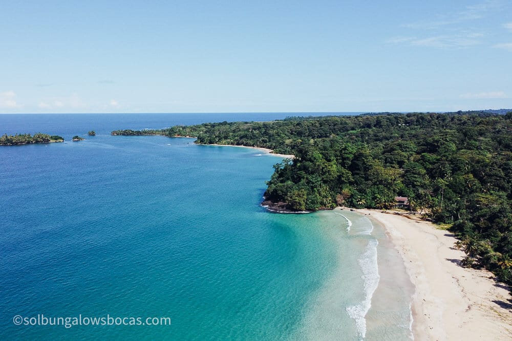 Drone of Red Frog Beach on Isla Bastimentos in the Bocas del Toro Archipelago of Panama. The view is from a drone with green jungle and turquoise water.