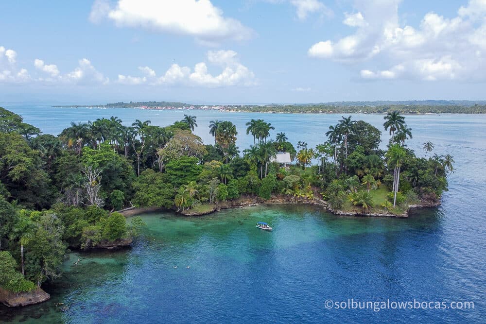 A drone view of hospital point on isla solarte with bocas town and isla carenero in the background.