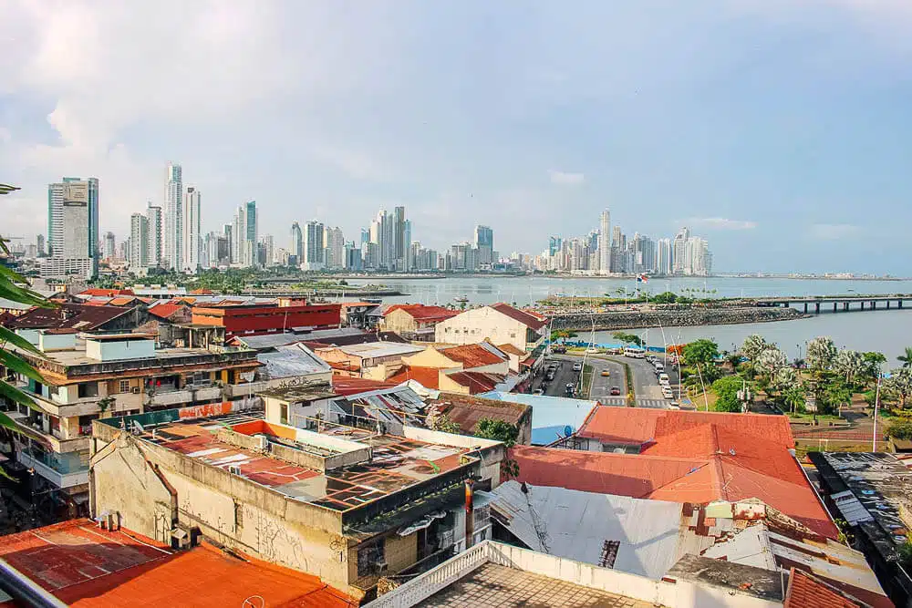 casco viejo in panama with the new panama city skyline in the distance with blue sky