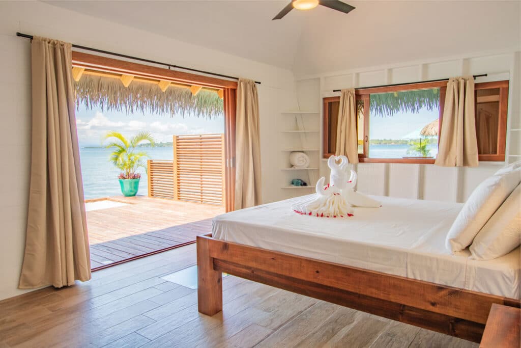 Enjoy a stunning view from the king size bed of your overwater bungalow.